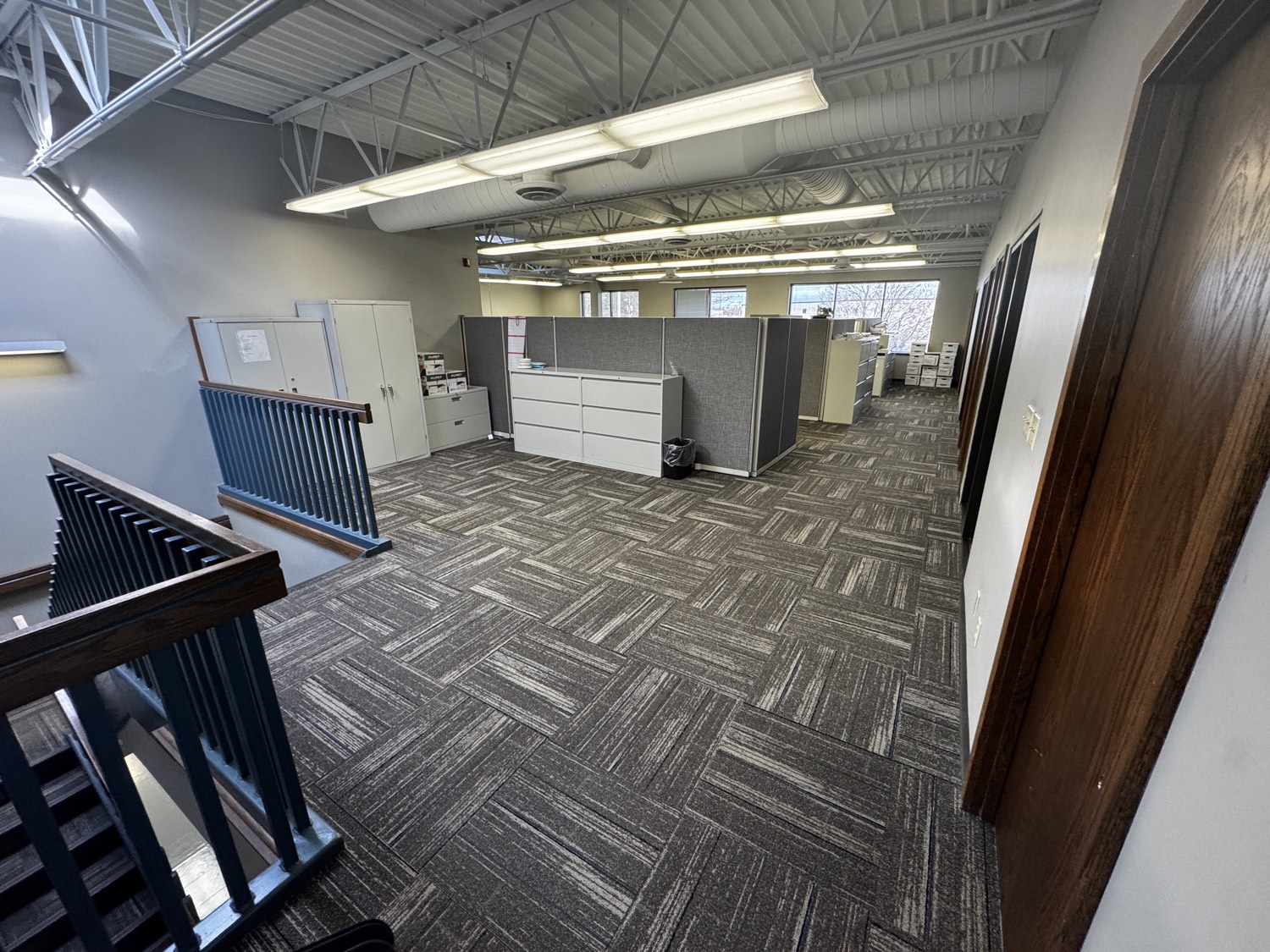 Commercial office interior build-out with exposed structure and new flooring